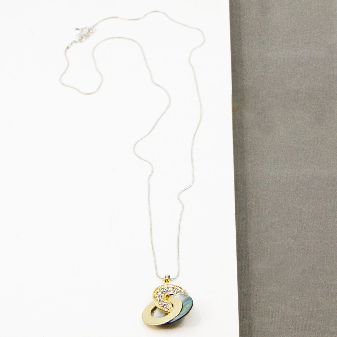 Long necklace with crystal encrusted link & mother of pearl disc
